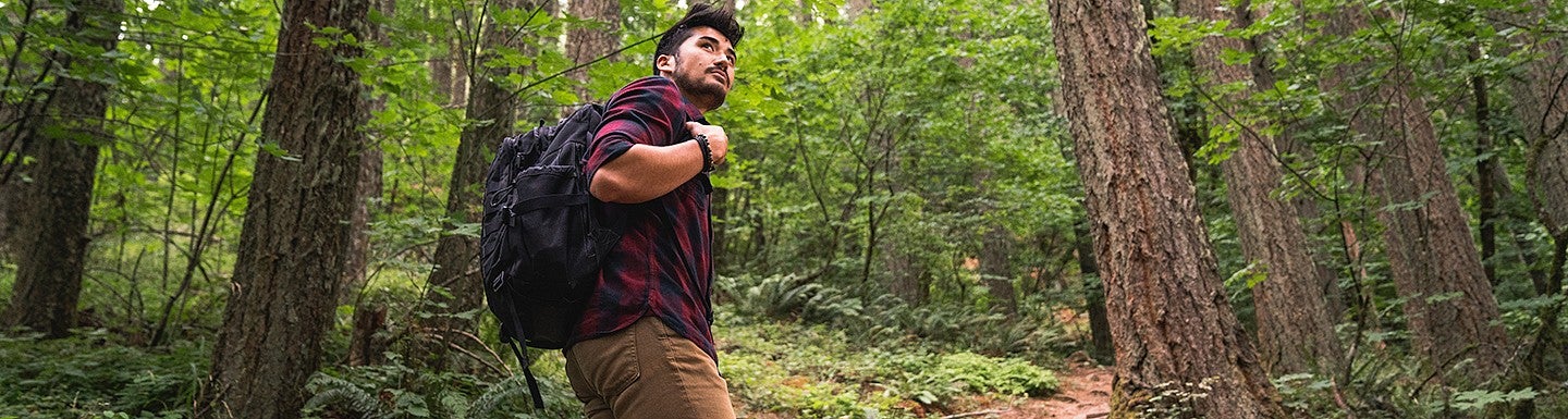 student hiking in the woods